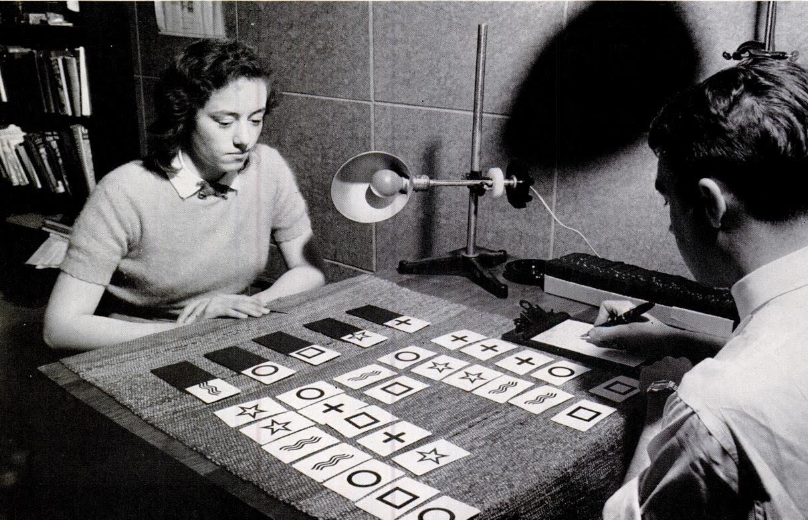 Image of two people reading cards